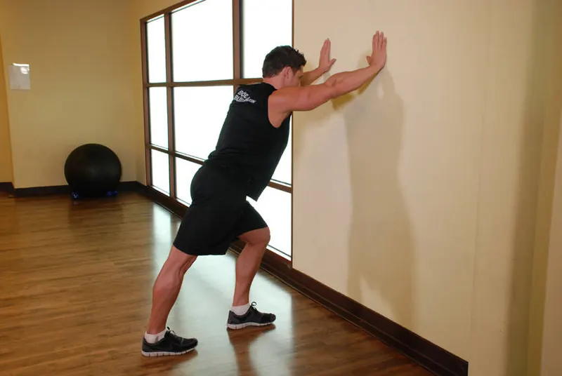 Calf Stretch Hands Against Wall: starting position