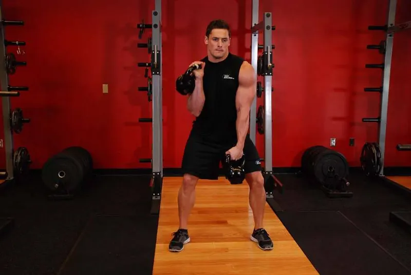 Double Kettlebell Alternating Hang Clean: end position