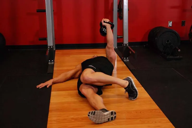 Extended Range One-Arm Kettlebell Floor Press: end position