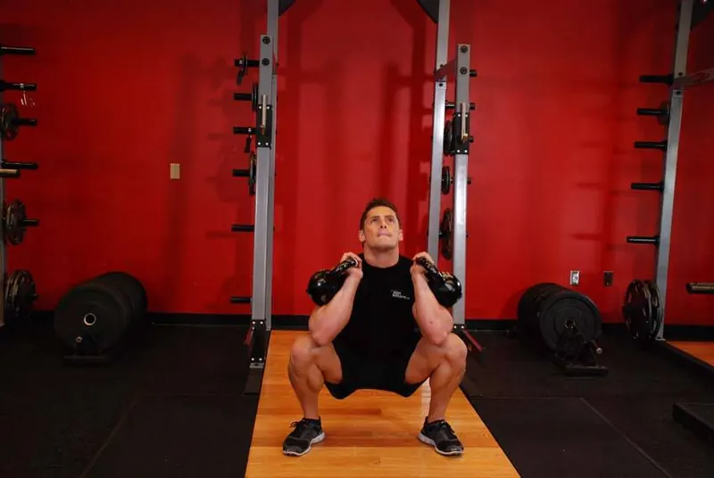 Front Squats With Two Kettlebells: end position