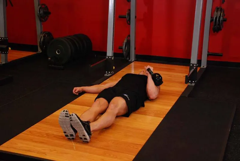 One-Arm Kettlebell Floor Press: starting position
