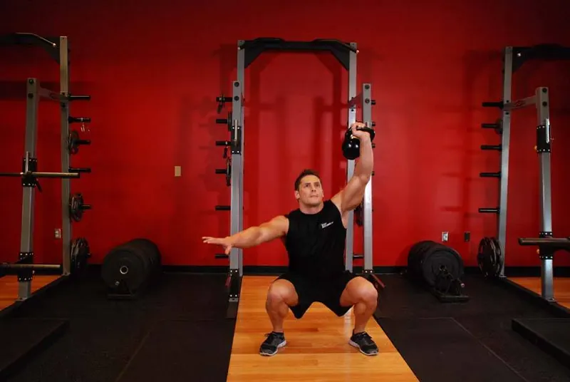 One-Arm Overhead Kettlebell Squats: end position