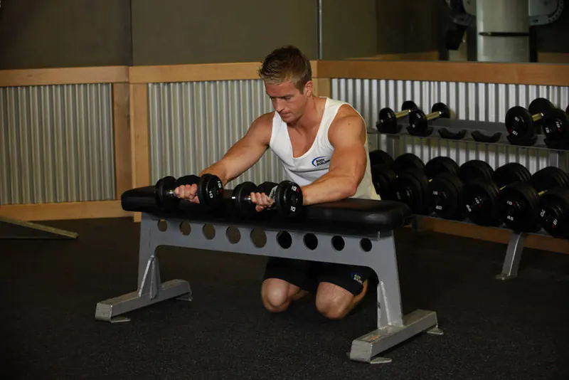 Palms-Down Dumbbell Wrist Curl Over A Bench: end position
