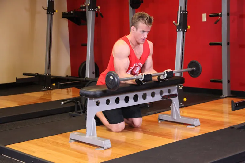 Palms-Up Barbell Wrist Curl Over A Bench: end position