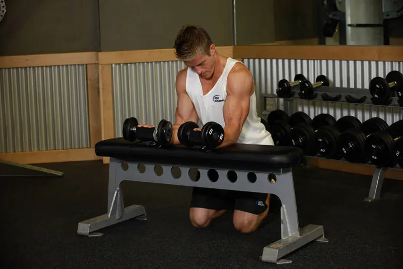 Palms-Up Dumbbell Wrist Curl Over A Bench: end position