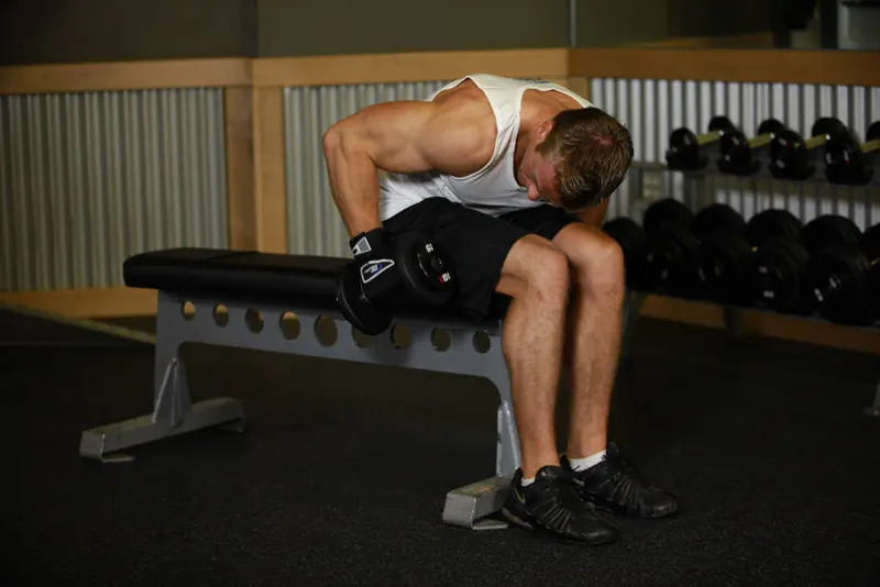 Seated Bent-Over One-Arm Dumbbell Triceps Extension: starting position