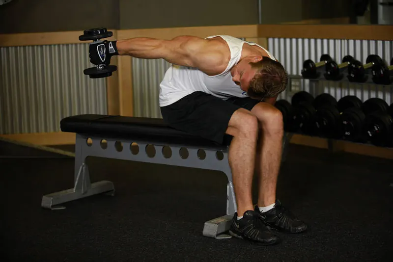 Seated Bent-Over One-Arm Dumbbell Triceps Extension: end position