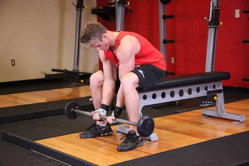 Seated Close-Grip Concentration Barbell Curl: starting position