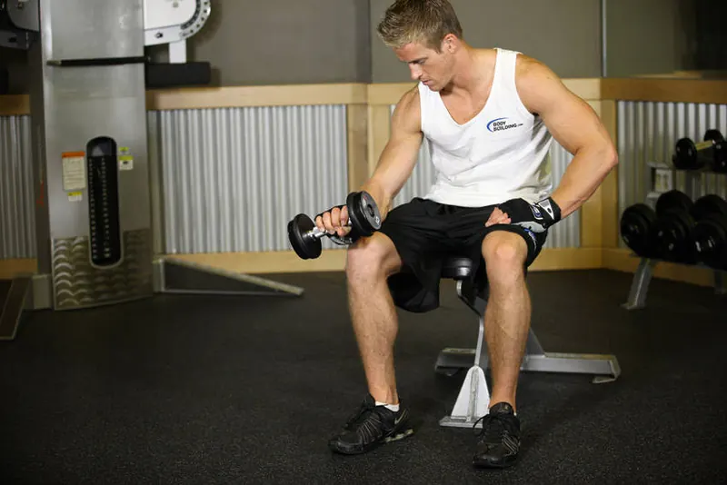 Seated One-Arm Dumbbell Palms-Down Wrist Curl: end position