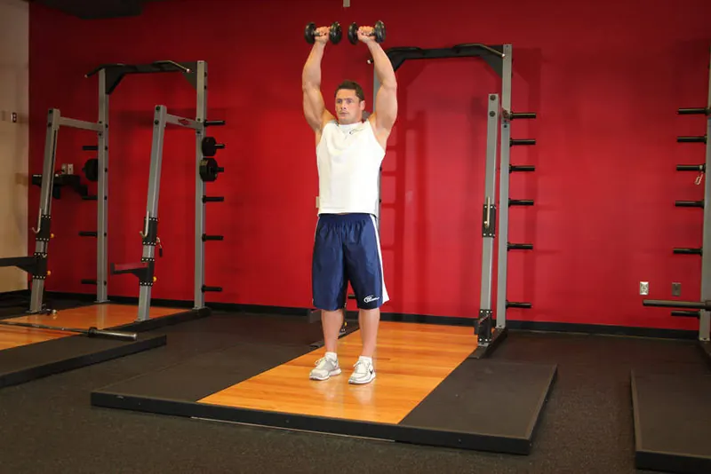 Standing Dumbbell Straight-Arm Front Delt Raise Above Head: end position
