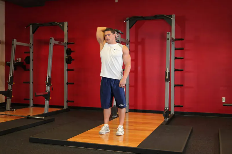Standing One-Arm Dumbbell Triceps Extension: end position