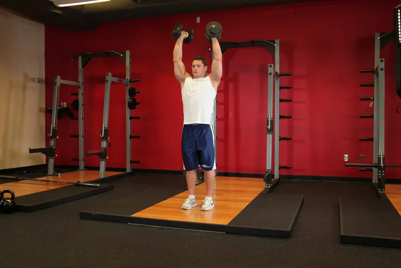 Standing Palms-In Dumbbell Press: starting position