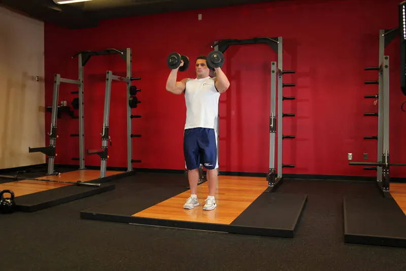 Standing Palms-In Dumbbell Press: end position