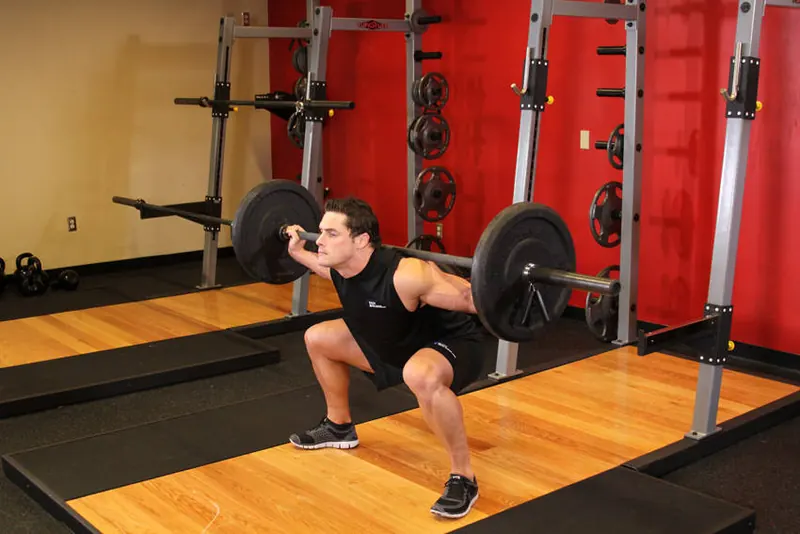 Wide Stance Barbell Squat: end position